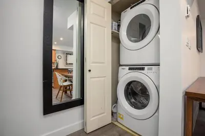 a laundry room with a washer and dryer at 2BR plus Loft in Valhalla, Village Location, Covered Patio, King Bed, Hot Tub in Whistler