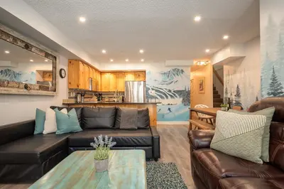 a living room with a couch and a table at 2BR plus Loft in Valhalla, Village Location, Covered Patio, King Bed, Hot Tub in Whistler