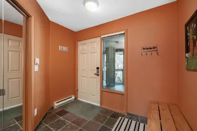 a hallway with orange walls and a door at 2BR in The Lynx, Family Sized, Mountain Views, Private Balcony, Tranquil Location, Parking in Whistler