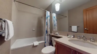 a bathroom with a sink and a toilet and a tub at 3BR in Montbello, Cozy Townhouse, Private Hot Tub, Near Village, Fireplace in Whistler