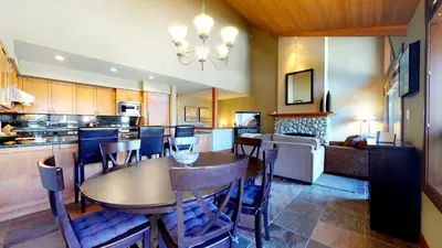 a kitchen and dining room with a table and chairs at 3BR in Montbello, Cozy Townhouse, Private Hot Tub, Near Village, Fireplace in Whistler