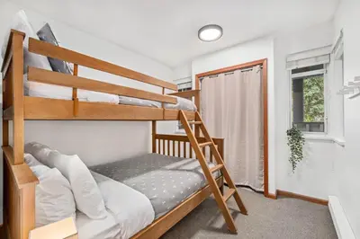 a bedroom with two bunk beds and a window at 3BR in Lagoons, King Bed, Private Balcony, Village Location, Parking in Whistler