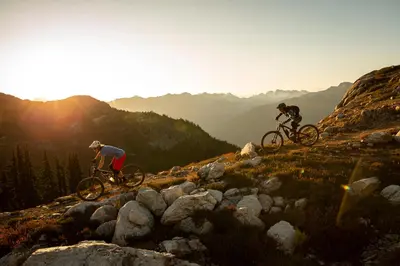two people riding bikes on top of a mountain at 3BR in Lagoons, King Bed, Private Balcony, Village Location, Parking in Whistler