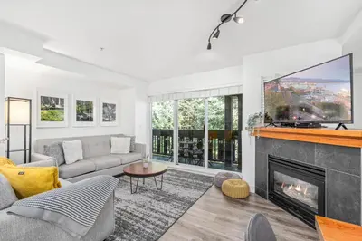 a living room with a fireplace and a tv at 3BR in Lagoons, King Bed, Private Balcony, Village Location, Parking in Whistler