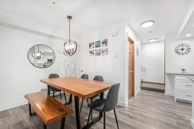 a dining room with a wooden table and chairs at 3BR in Lagoons, King Bed, Private Balcony, Village Location, Parking in Whistler