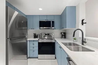 a kitchen with blue cabinets and a sink at 1BR in Northstar, Village Location, Shared Pool and Hot Tub, Ski Storage, Free Parking in Whistler