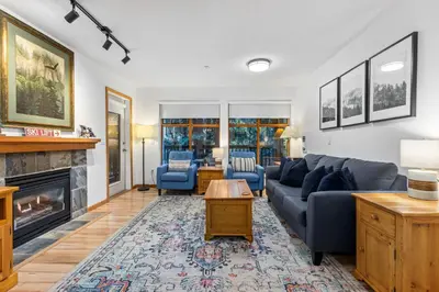 a living room with a couch and a fireplace at 1BR in Northstar, Village Location, Shared Pool and Hot Tub, Ski Storage, Free Parking in Whistler