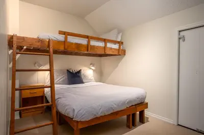 a bedroom with two bunk beds in a room at 2BR plus Den in The Gables, Dog Friendly, Near Both Mountains, Wood Burning Fireplace, Free Parking in Whistler