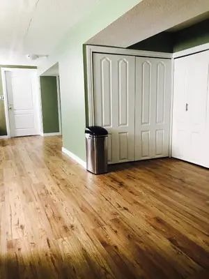 an empty room with a door and a trash can at Private Rooms in a 3 Bedroom Guest House Close to Kingsway NAIT 1 Person per Room No Couples For Men Only in Edmonton