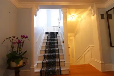 a stairway leading up to a room with a window at Lipton Place by Elegant Waterfront in Victoria