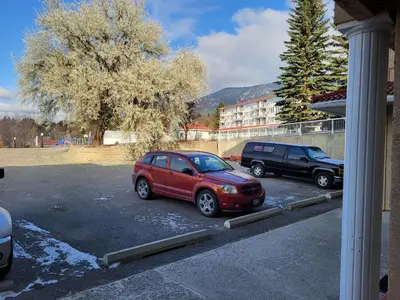 a red car is parked in a parking lot at Fairmont Mountain View Villas in Fairmont Hot Springs