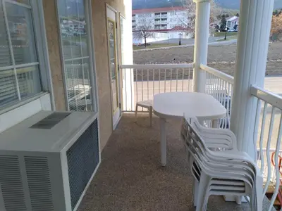 a porch with a table and chairs and a table at Fairmont Mountain View Villas in Fairmont Hot Springs
