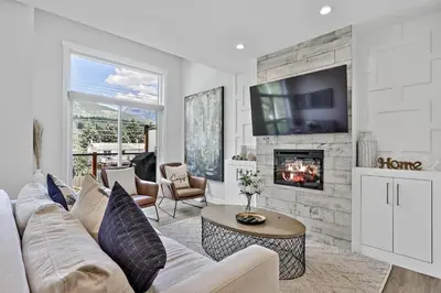 a living room with a couch and a fireplace at The Alpine Escape by Samsara Resort Top View Downtown 4BR & 3BTH in Canmore