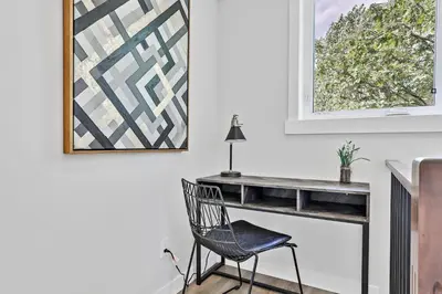 a desk in a room with a chair and a picture at The Alpine Escape by Samsara Resort Top View Downtown 4BR & 3BTH in Canmore