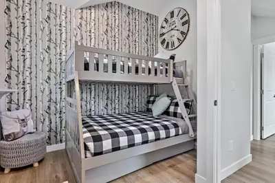a childs room with a bunk bed and a clock at The Alpine Escape by Samsara Resort Top View Downtown 4BR & 3BTH in Canmore