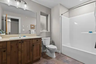a bathroom with a toilet and a sink and a shower at Echo Landing #42 by Bear Country in Sun Peaks