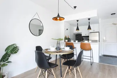 a kitchen and dining room with a table and chairs at Contemporary & Spacious Slopeside 1BR Getaway in Whistler