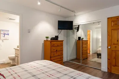 a bedroom with a bed and a dresser and a mirror at 3BR in Valhalla, Village Location, Communal Hot Tub, Gas Fireplace, Parking in Whistler