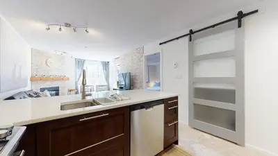 a kitchen with a sink and a counter at 1BR and Den in Marketplace Lodge, Gas Fireplace, Village Location, Complex Hot Tub in Whistler