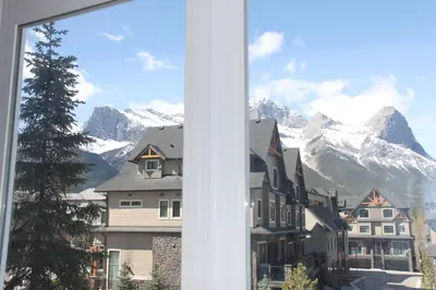 a view of a mountain from a window at Windtower Lodge - Canmore in Canmore