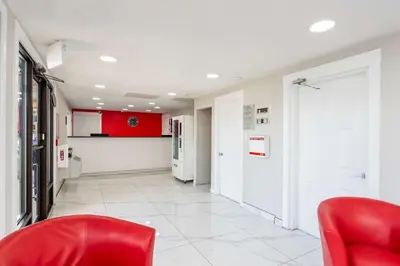a hallway with red chairs in a hospital at Econo Lodge in Prince George
