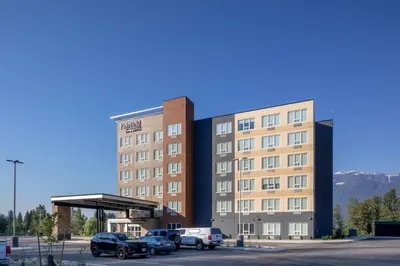 a large building with cars parked in a parking lot at Fairfield by Marriott Inn & Suites Revelstoke in Revelstoke