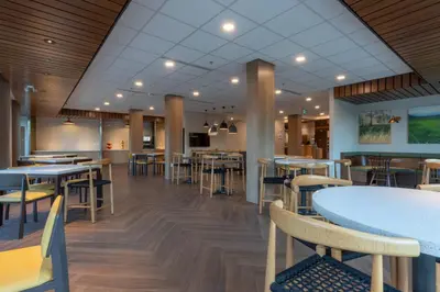 a dining area with tables and chairs in a restaurant at Fairfield by Marriott Inn & Suites Revelstoke in Revelstoke