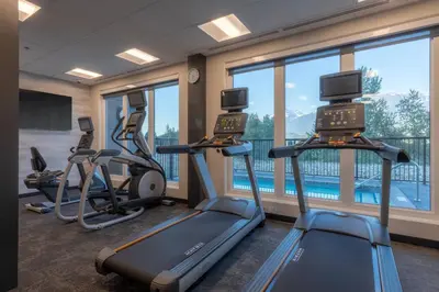 a fitness room with treadmills and elliptical machines at Fairfield by Marriott Inn & Suites Revelstoke in Revelstoke