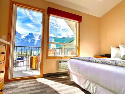 a bedroom with a bed and a window with a view at MountainView -PrivateChalet Sleep7- 5min to DT Vacation Home in Canmore