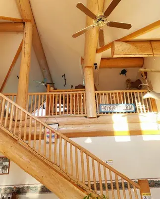 a staircase in a house with a ceiling fan at Bear's Claw Lodge in Cache Creek