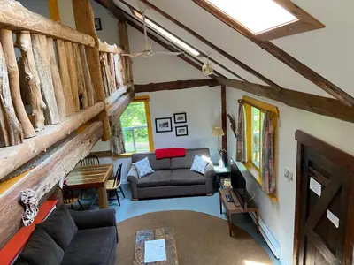 a living room with a couch and a table at Woods End Landing in Bamfield