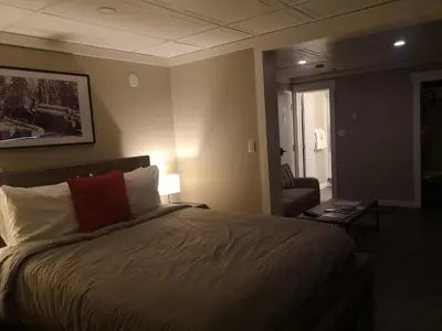 a bedroom with a large bed with a red pillow at The Cache Hotel and Lodgings in Golden