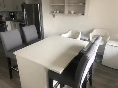 a kitchen with a white table and chairs at Hearthstone Lodge loft, Village centre, Private Hot tub, sleeps 6 in Whistler