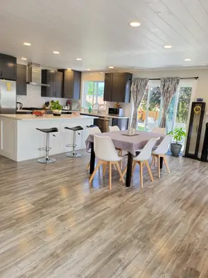 a kitchen and dining room with a table and chairs at JoyVeal’s Homey Place in Sechelt