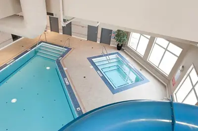 an overhead view of two swimming pools in a building at Paradise Inn and Suites in Valleyview