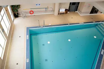 an overhead view of a swimming pool in a building at Paradise Inn and Suites in Valleyview