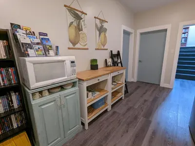 a living room with a microwave on a counter at Maple Rise Guesthouse in Duncan