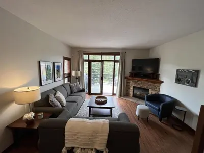 a living room with a couch and a fireplace at Trappers Landing #34 by Bear Country in Sun Peaks