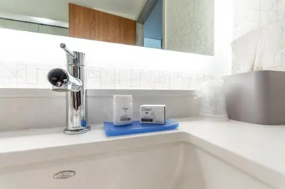a bathroom with a sink with a faucet and two cups at Holiday Inn Express & Suites - Chilliwack East an IHG Hotel in Chilliwack