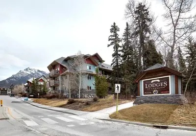 a sign for a hotel on the side of a street at Newly Renovated Grizzly Lodge, Spacious 3BR 2BA with open pool, hot tub in Canmore