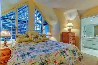 a bedroom with a large bed and a window at Wintergreen 27 - Townhome in Whistler