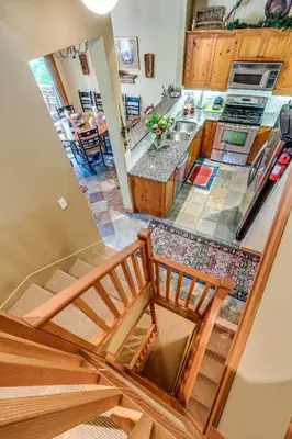 a view of a kitchen from the top floor of a house at Mountain Star 28 Hot Tub in Whistler