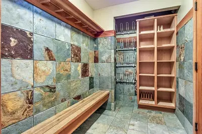 a walk in shower with a stone wall at Mountain Star 28 Hot Tub in Whistler