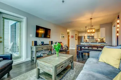 a living room with a couch and a table at Greystone Lodge 221 Ski-in Out in Whistler