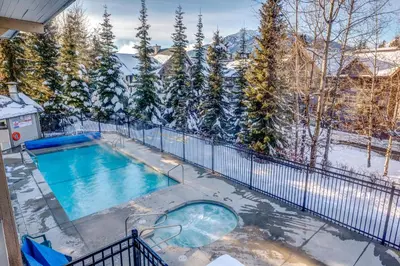 a swimming pool in the snow on a house at Greystone Lodge 207 Ski-in Out in Whistler