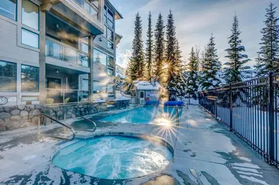 a hot tub in the backyard of a house at Greystone Lodge 412 Renovated in Whistler