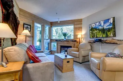 a living room with two couches and a fireplace at Greystone Lodge 229 Ski-in Out in Whistler