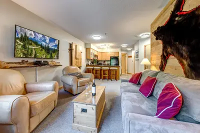 a living room with a couch and a table at Greystone Lodge 229 Ski-in Out in Whistler