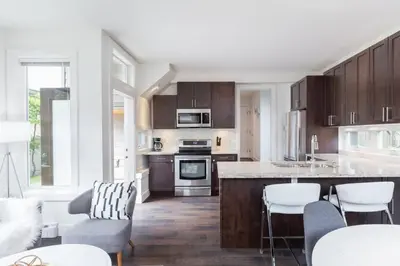 a kitchen with wooden cabinets and a counter top at West Coast Luxury Living in Vancouver