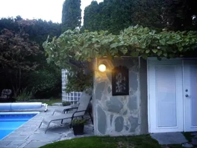 a stone building with a bench next to a pool at The Stone Hedge Bed and Breakfast in Richmond